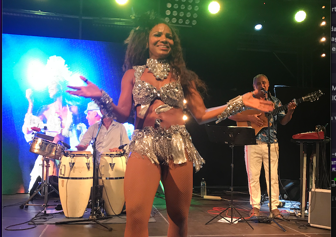 Sueli en costume argenté, entourée des musiciens